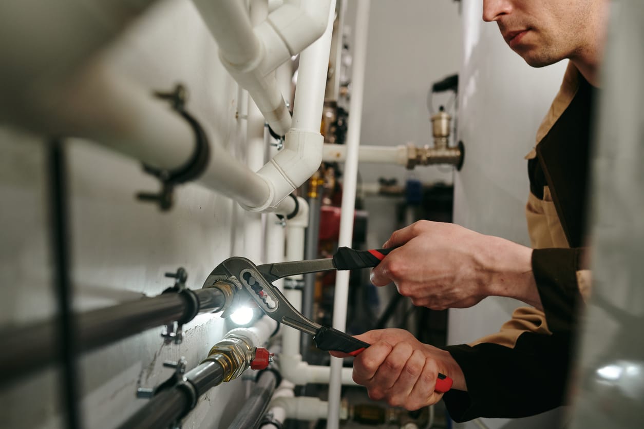Plumbers maintaining commercial plumbing pipes in Holly Springs