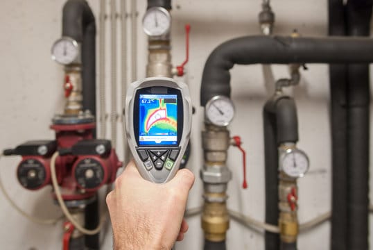 Plumber using a thermal imaging camera to inspect pipes in Holly Springs