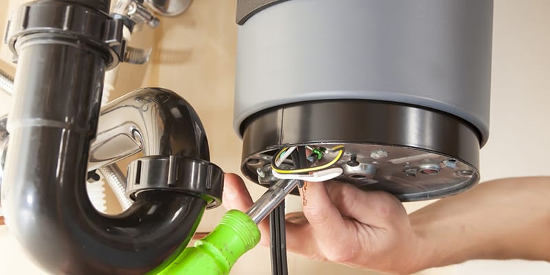 Technician repairing the heating element of a water heater in Holly Springs